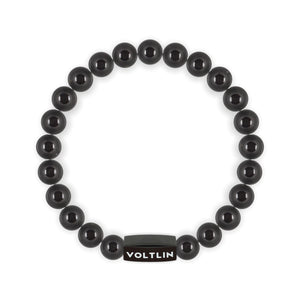 Top view of an 8mm Black Tourmaline crystal beaded stretch bracelet with black stainless steel logo bead made by Voltlin