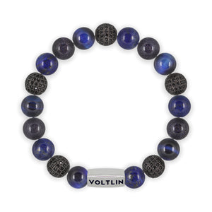 Top view of a 10mm Blue Sirius beaded stretch bracelet featuring Blue Tiger’s Eye, Black Pave, Lapis Lazuli, & Blue Goldstone crystal and silver stainless steel logo bead made by Voltlin