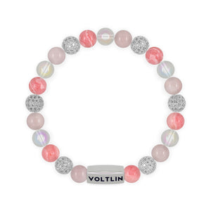 Top view of an 8mm Pink Sirius beaded stretch bracelet featuring Rose Quartz, Silver Pave, Rhodochrosite, & Angel Aura Quartz crystal and silver stainless steel logo bead made by Voltlin