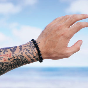 Male arm wearing our beaded Shungite Stretch Bracelet from Voltlin