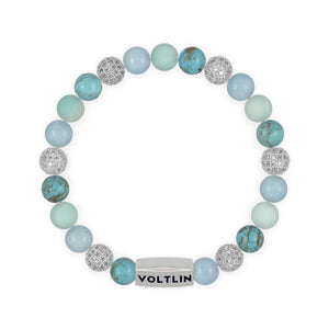 Top view of an 8mm Turquoise Sirius beaded stretch bracelet featuring Turquoise, Silver Pave, Aquamarine, & Matte Amazonite crystal and silver stainless steel logo bead made by Voltlin