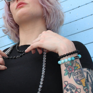 A female model wearing our Larimar Stretch Bracelet from Voltlin