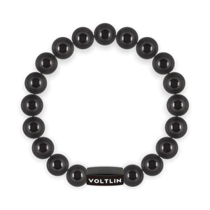 Top view of a 10mm Black Tourmaline crystal beaded stretch bracelet with black stainless steel logo bead made by Voltlin