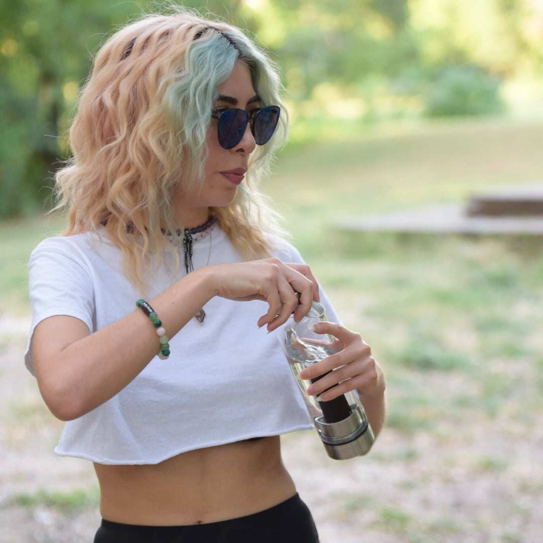 Front view of an 8mm Heart Chakra beaded stretch bracelet featuring Malachite, Rose Quartz, Jade, & Green Aventurine crystal and silver stainless steel logo bead made by Voltlin