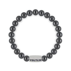 Top view of an 8mm Hematite beaded stretch bracelet with silver stainless steel logo bead made by Voltlin