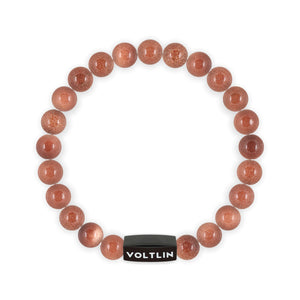 Top view of an 8mm Red Goldstone crystal beaded stretch bracelet with black stainless steel logo bead made by Voltlin