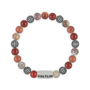 Top view of an 8mm Sienna Sirius beaded stretch bracelet featuring Carnelian, Steel Pave, Smooth Botswana Agate, & Red Goldstone crystal and silver stainless steel logo bead made by Voltlin