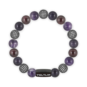 Top view of a 10 mm Violet Sirius beaded stretch bracelet featuring Amethyst, Steel Pave, Blue Goldstone, & Smooth Garnet crystal and black stainless steel logo bead made by Voltlin
